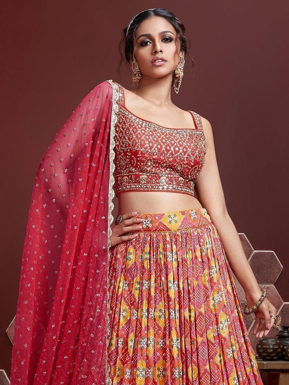 Red designer lehenga choli with matching net dupatta and lace details.