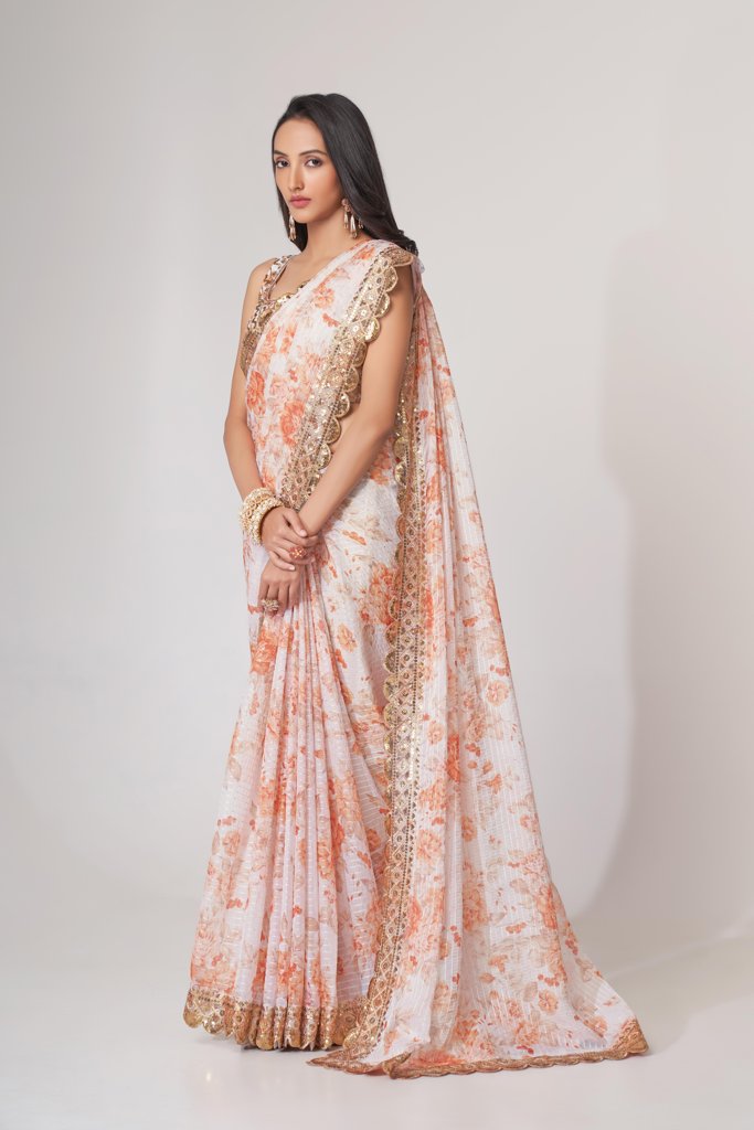 Lightweight white floral print organza saree with intricate sequin embroidery, perfect for celebrations.