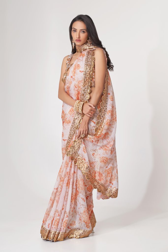 Graceful white saree with floral prints and delicate sequin embroidery, ideal for special events.