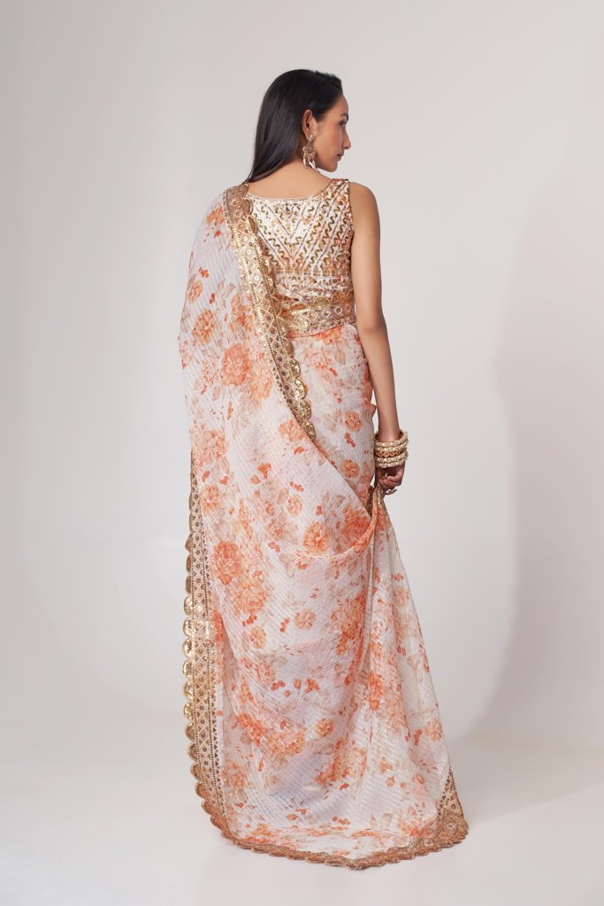 Stunning white floral print saree with sequin detailing, offering an elegant and modern look.