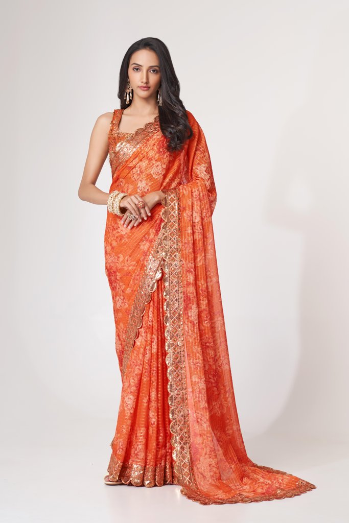 Timeless orange floral print organza saree with intricate sequin embroidery for traditional wear.