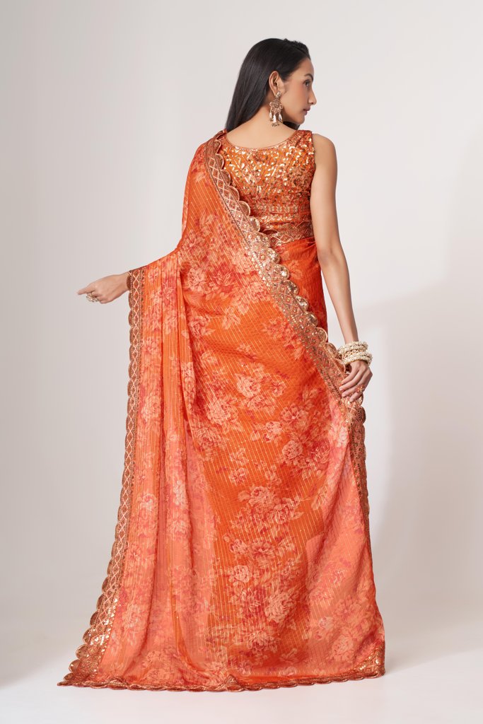 Elegant orange floral print saree with delicate sequin details, perfect for a chic look.