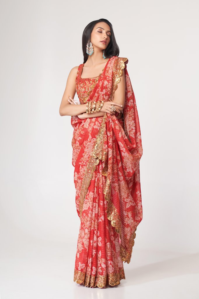 Elegant orange floral print saree in organza with sequin details, perfect for festive occasions.