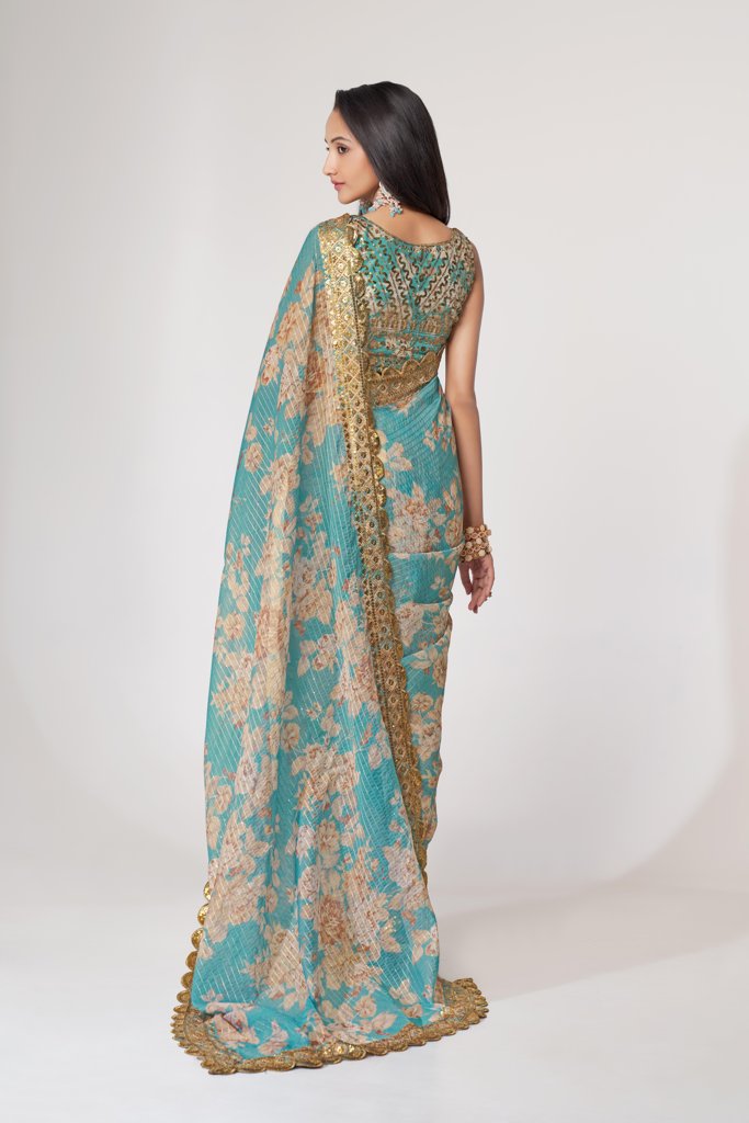 Beautiful sky-blue floral print saree with intricate sequin embroidery, perfect for weddings.