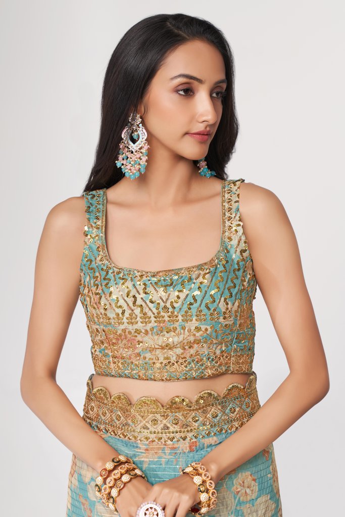 Elegant teal floral print saree in organza with sequin embroidery for a chic look.