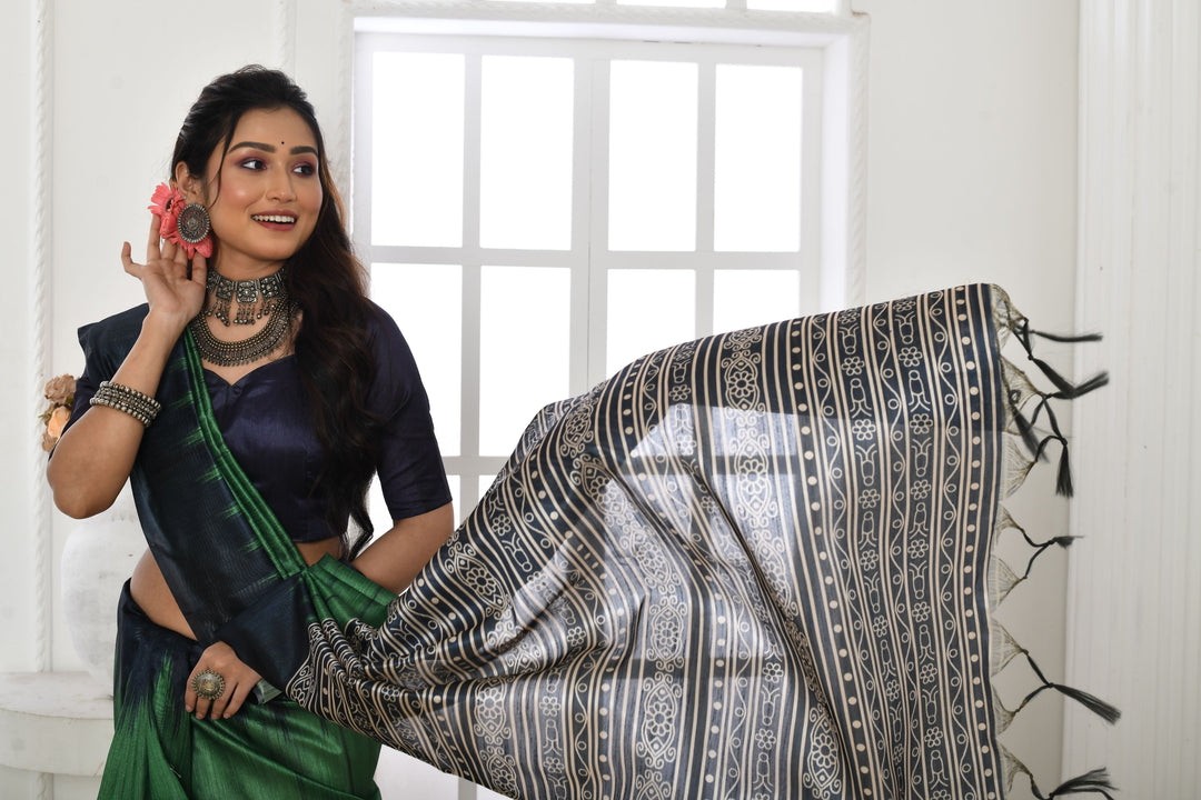 Printed Tussar silk saree with a traditional fabric pattern and matching blouse piece for festive events.