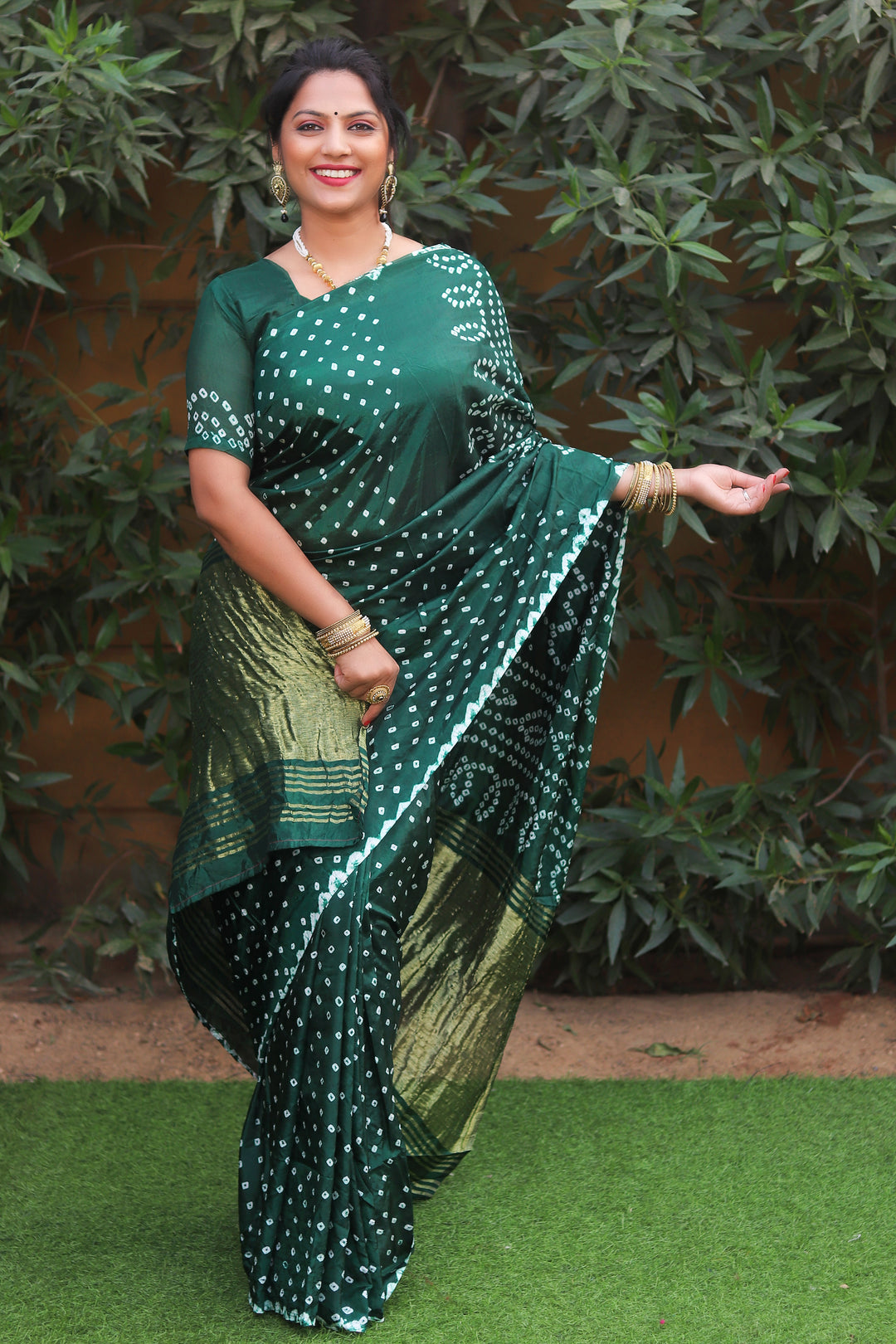 Rich teal green Bandhej silk saree featuring original Bandhej art and a Zari woven pallu, ideal for USA festivities.