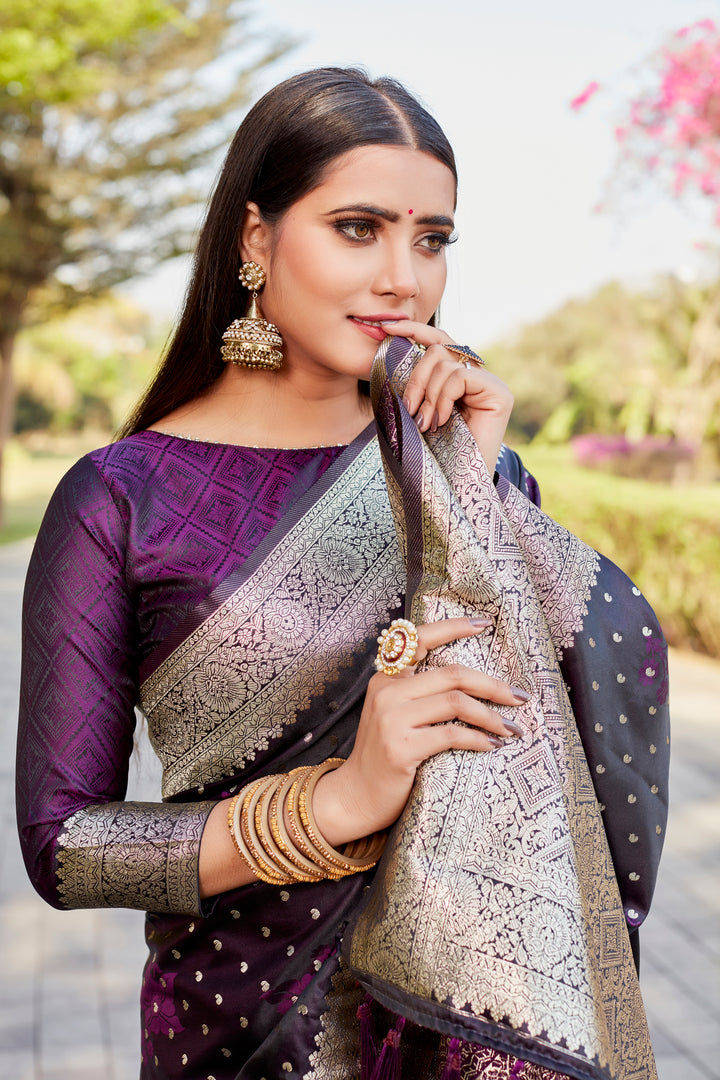 Rich dark-purple Satin Kanjivaram saree with intricate butta design and radiant finish.