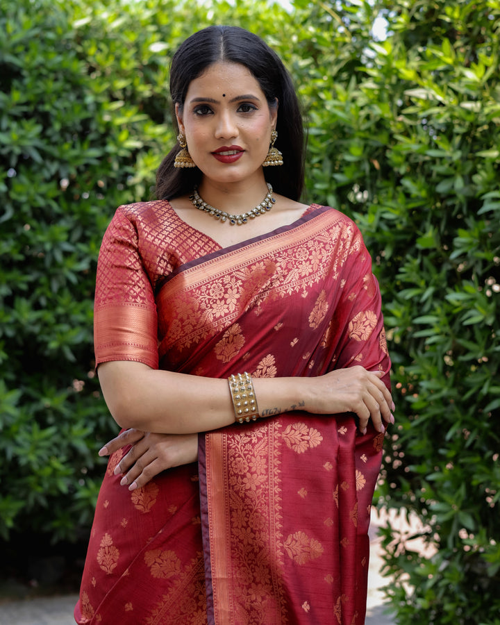 Rich maroon soft silk saree with intricate weaving and a regal, woven pallu, perfect for weddings.