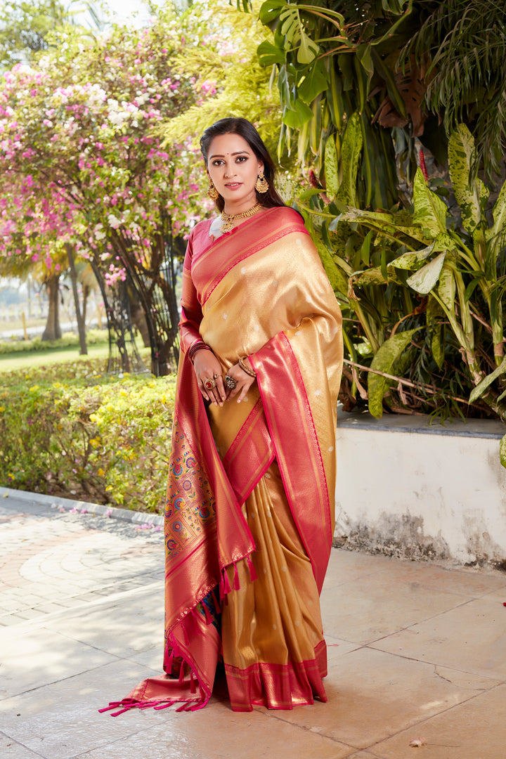 Beautiful beige tissue silk saree with a luxurious pallu and contrast blouse, ideal for elegant celebrations.