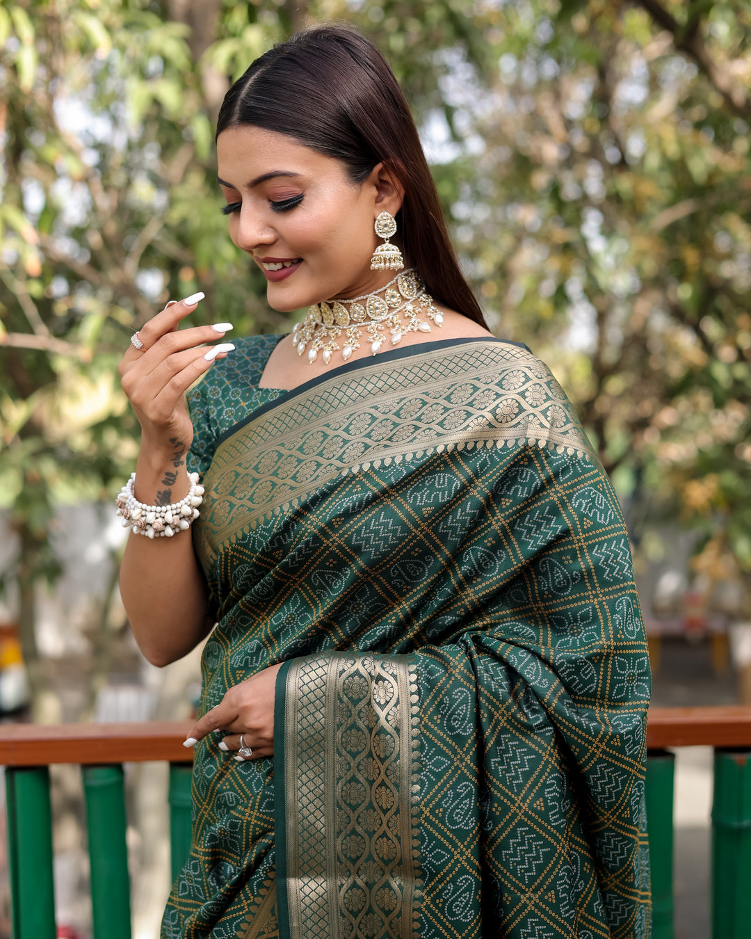 Traditional Indian saree in vibrant green, showcasing exquisite Bandhej patterns and a rich woven pallu.