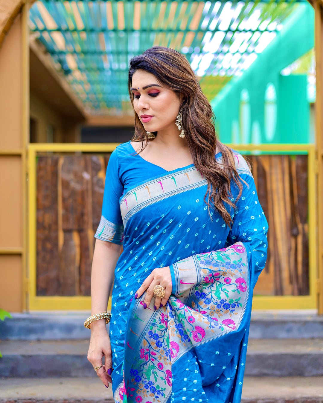 Blue Bandhej Paithani silk saree featuring zari weaving and matching tassels at the pallu, ideal for traditional events.