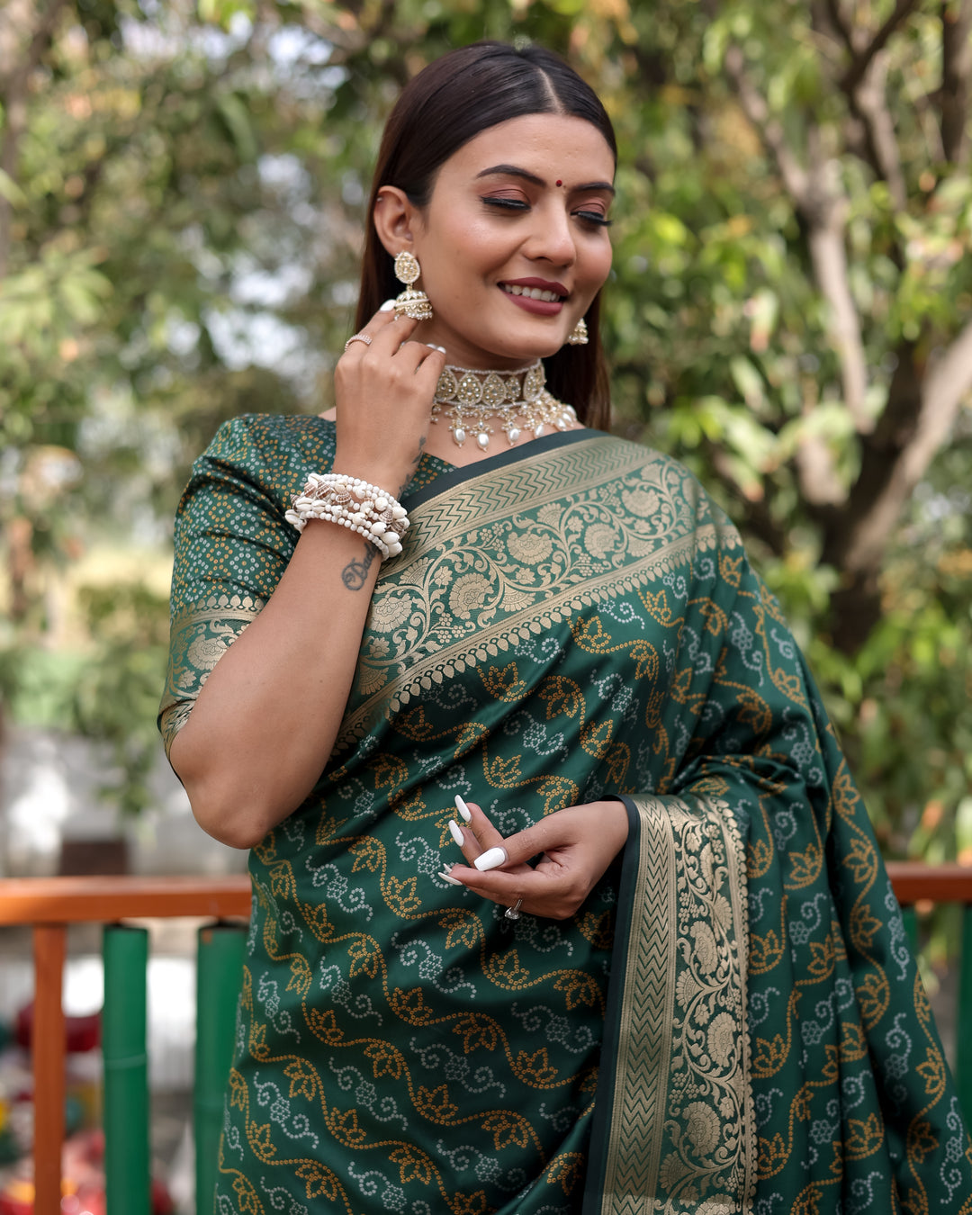 Vibrant green Bandhej Patola saree with exquisite zari detailing and regal Kanchi borders, ideal for weddings.