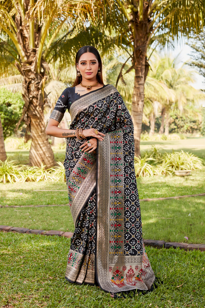 Gorgeous dark green Gharchola Bandhej silk saree with zari and meenakari borders, ideal for festive celebrations and cultural functions.