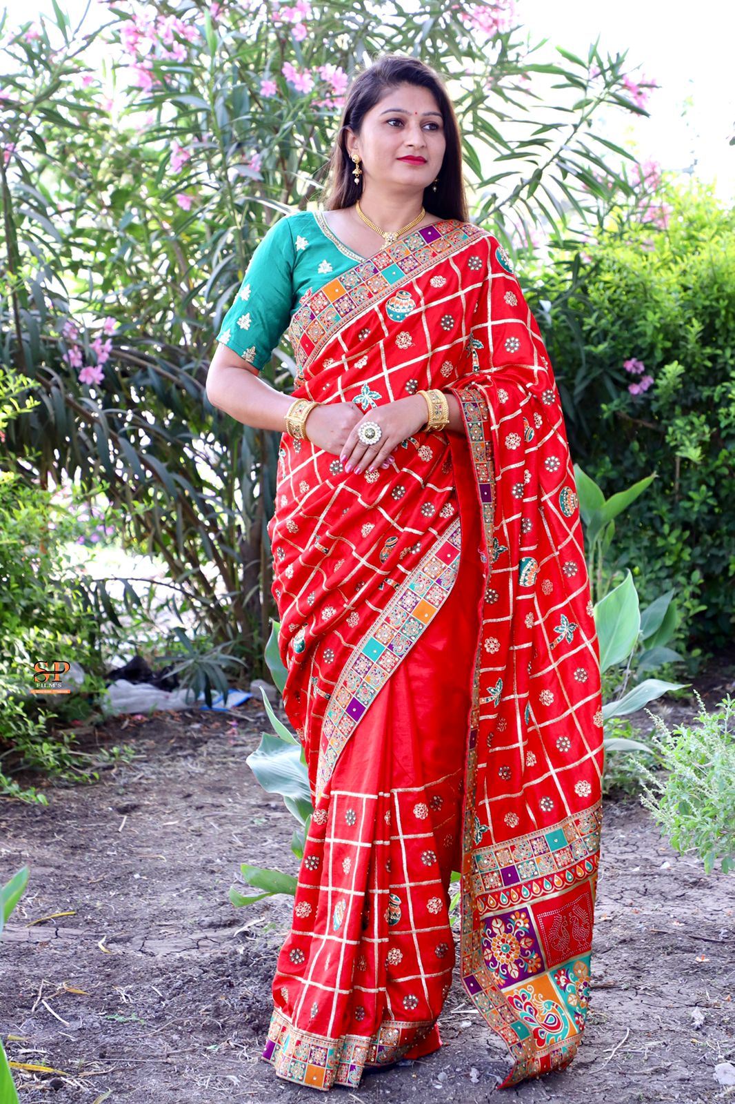 Red Dola Silk saree adorned with fine embroidery and diamond work, featuring a stunning jacquard lace border.