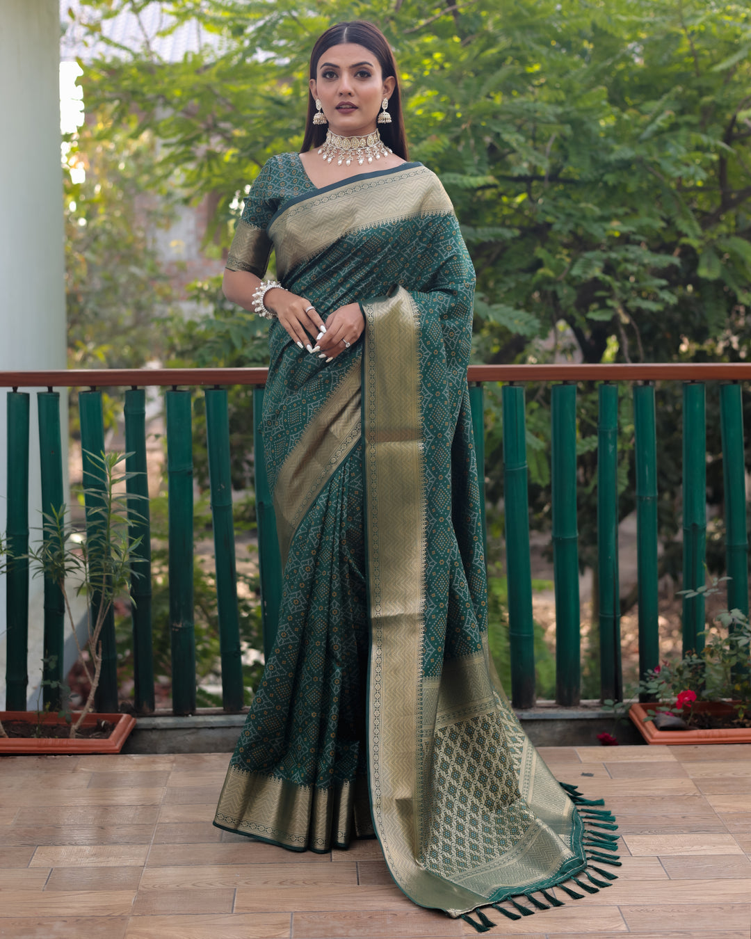 Stunning green Patola silk saree showcasing exquisite Bandhej designs and contrast zari borders, embodying elegance.