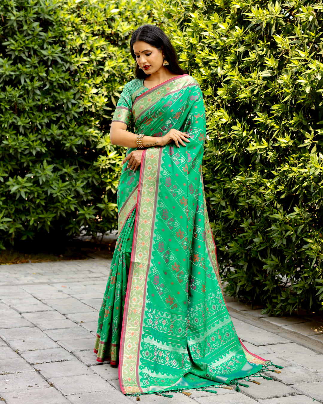 Fresh green Bandhej silk saree with zari woven pallu and matching blouse, perfect for festive and traditional occasions.