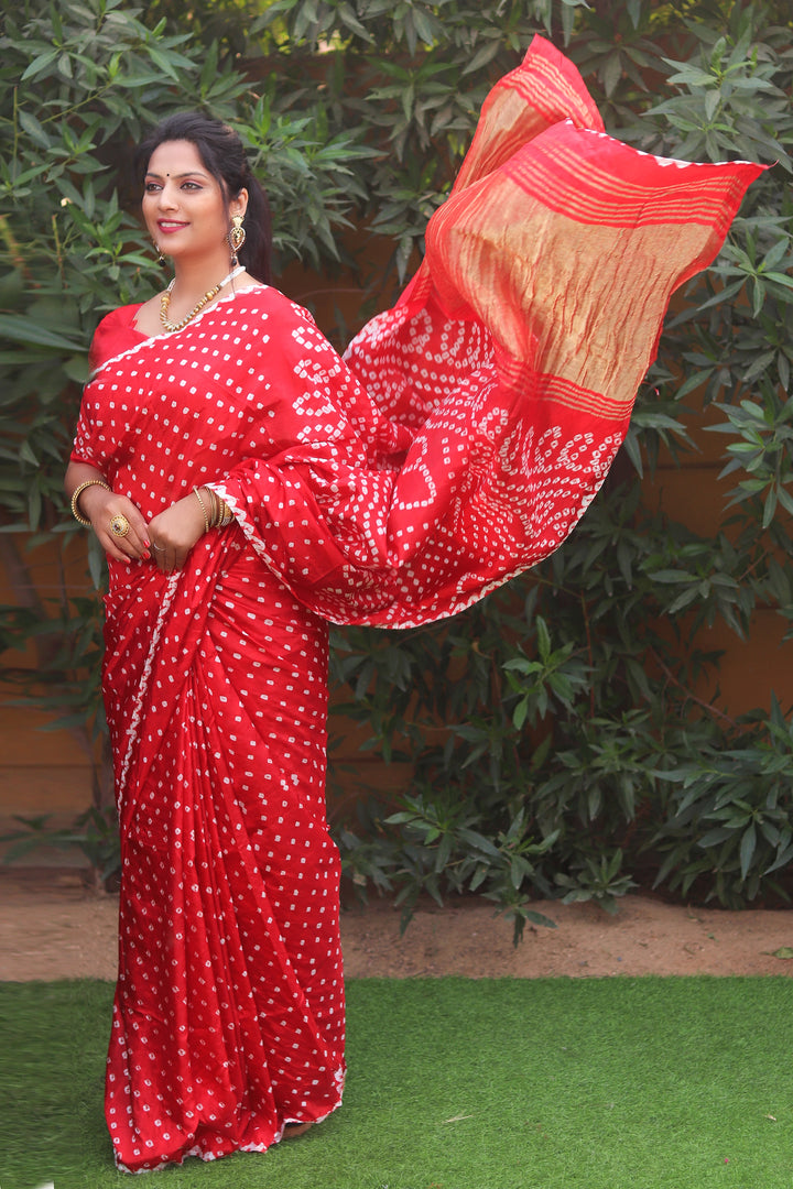 Red Bandhej silk saree with Zari Weaving pallu, a stunning choice for Indian festivities and wedding events.