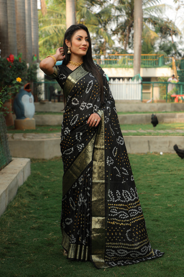 Elegant black Bandhej silk saree with a beautiful jari border and Bandhej pallu, perfect for formal and festive wear.