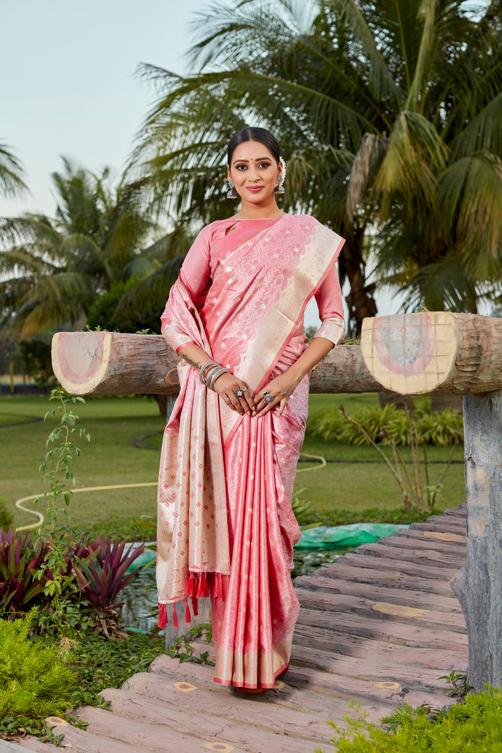 Elegant peach Kanjivaram silk saree with intricate butta work and designer border, perfect for bridal wear.