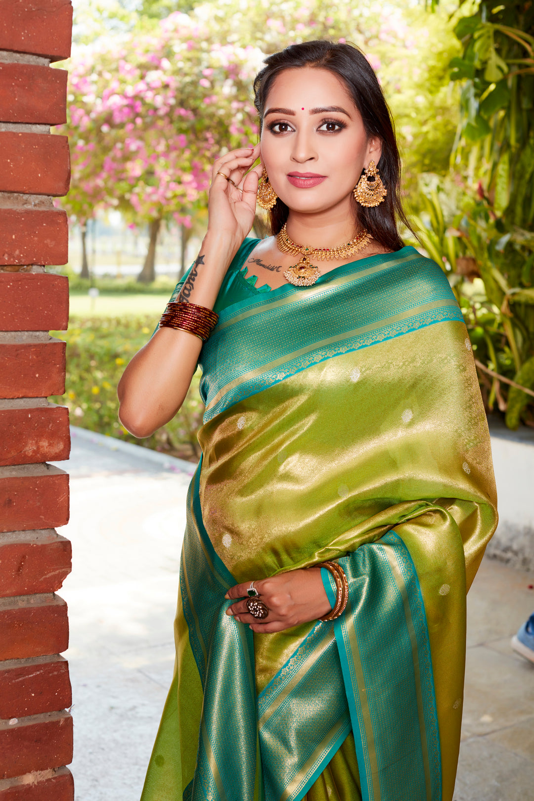 Elegant parrot-green tissue silk saree with rich pallu and contrast blouse, perfect for festive occasions.