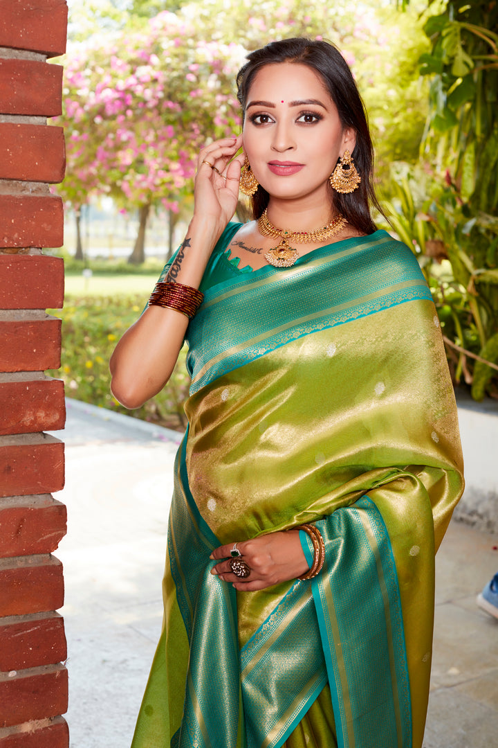 Elegant parrot-green tissue silk saree with rich pallu and contrast blouse, perfect for festive occasions.