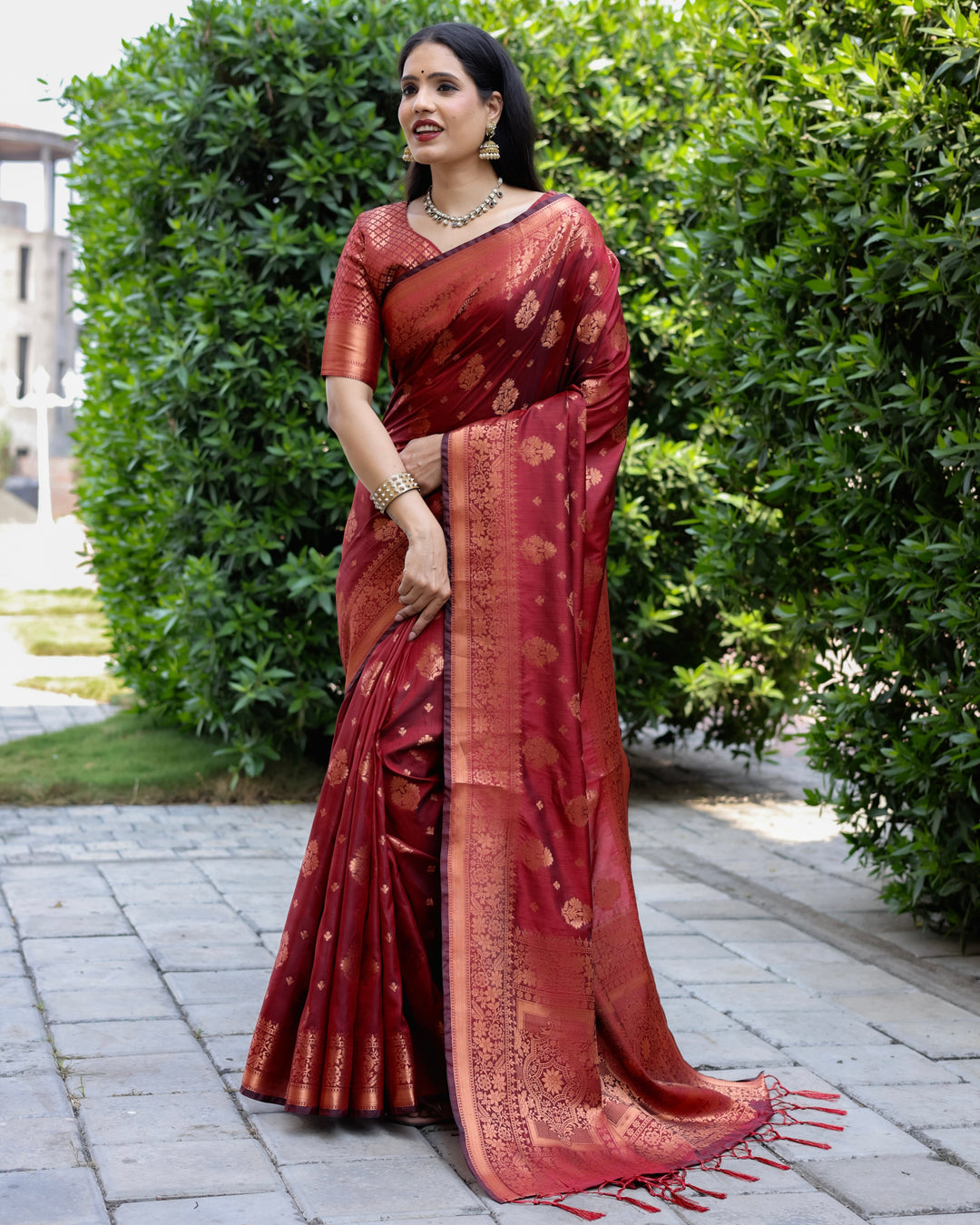 Traditional maroon soft silk saree with detailed copper weaving, paired with a contrast brocade blouse for added sophistication.