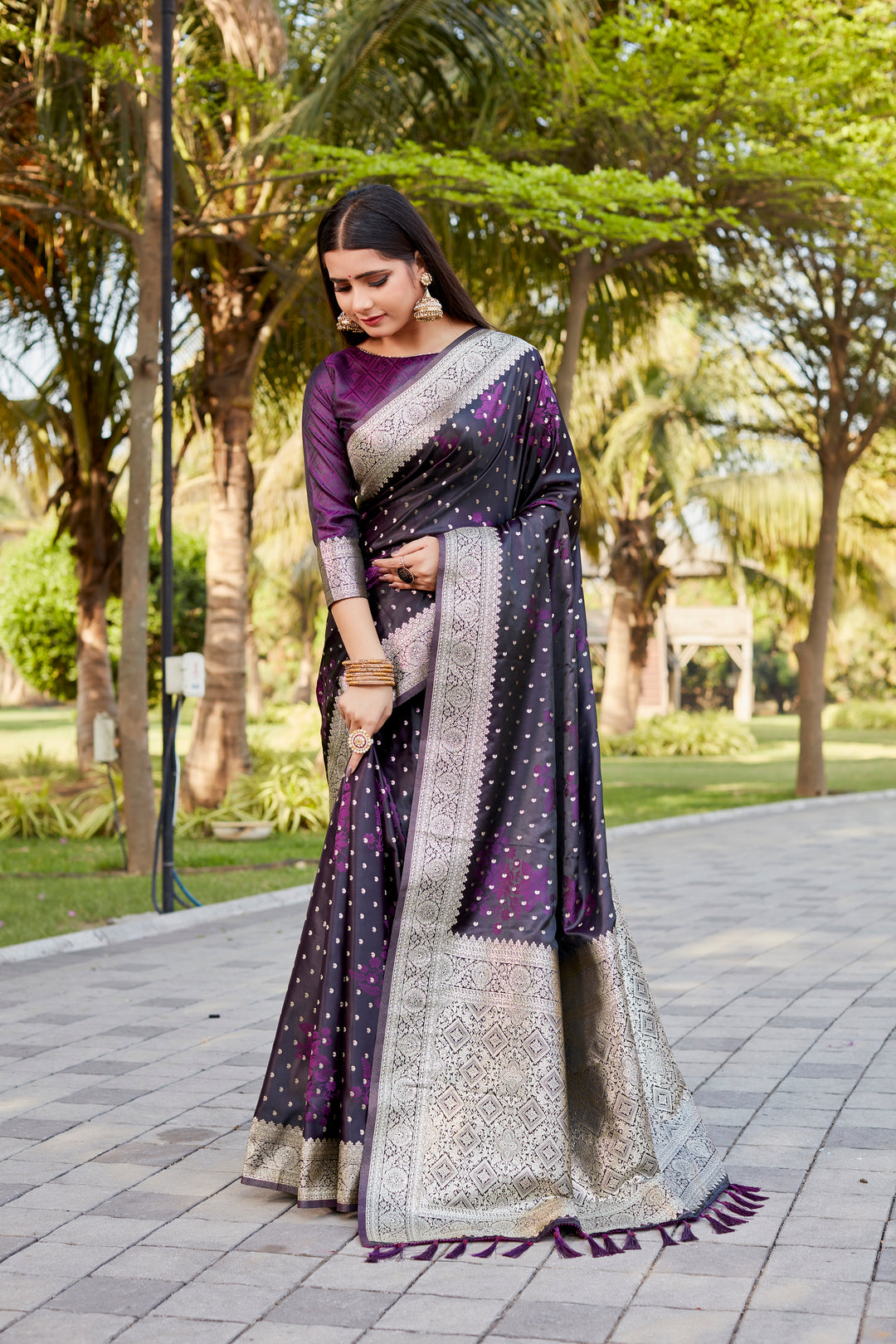 Elegant dark-purple Satin Kanjivaram saree with intricate butta motifs and shimmering effect.