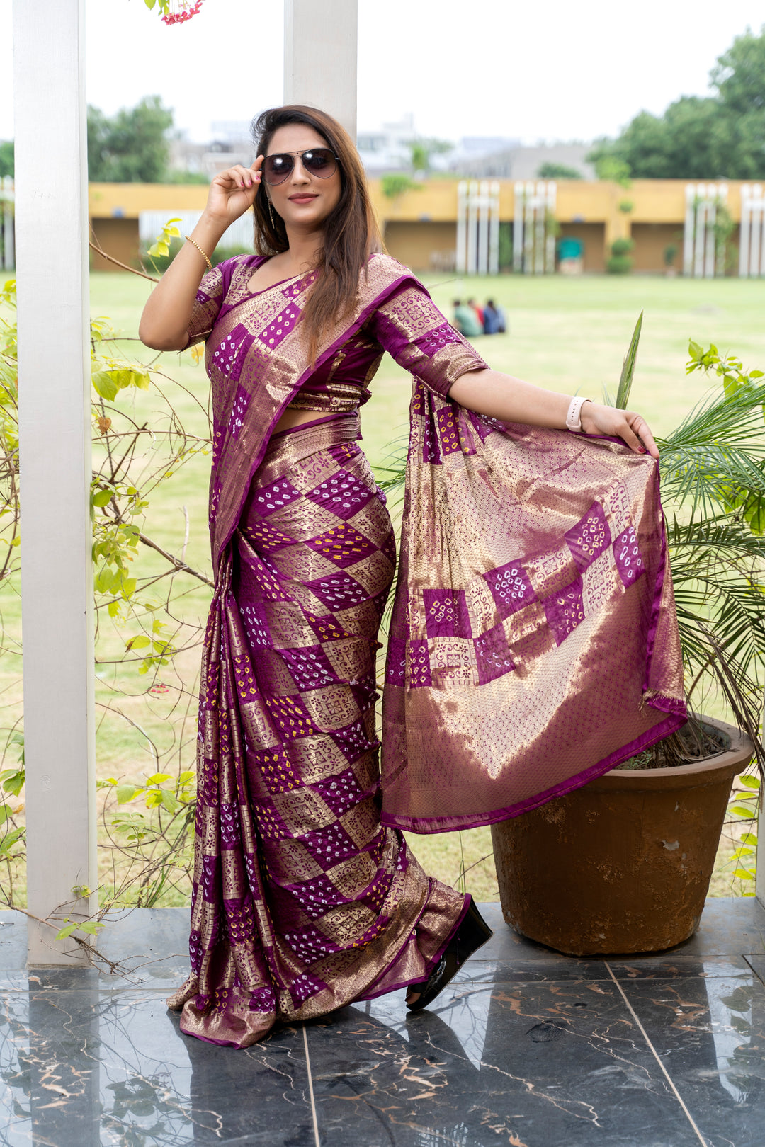 Graceful green Bandhej silk saree with intricate zari border, perfect for weddings and festive functions.