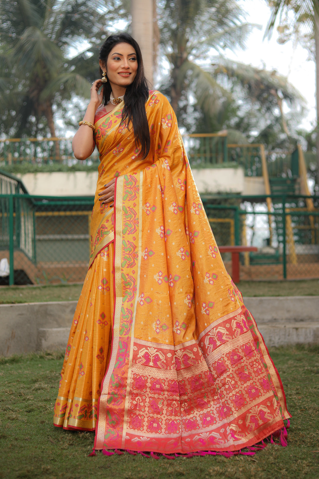 Elegant yellow organza saree with beautiful Ikkat Patola design, ideal for weddings and festivals.