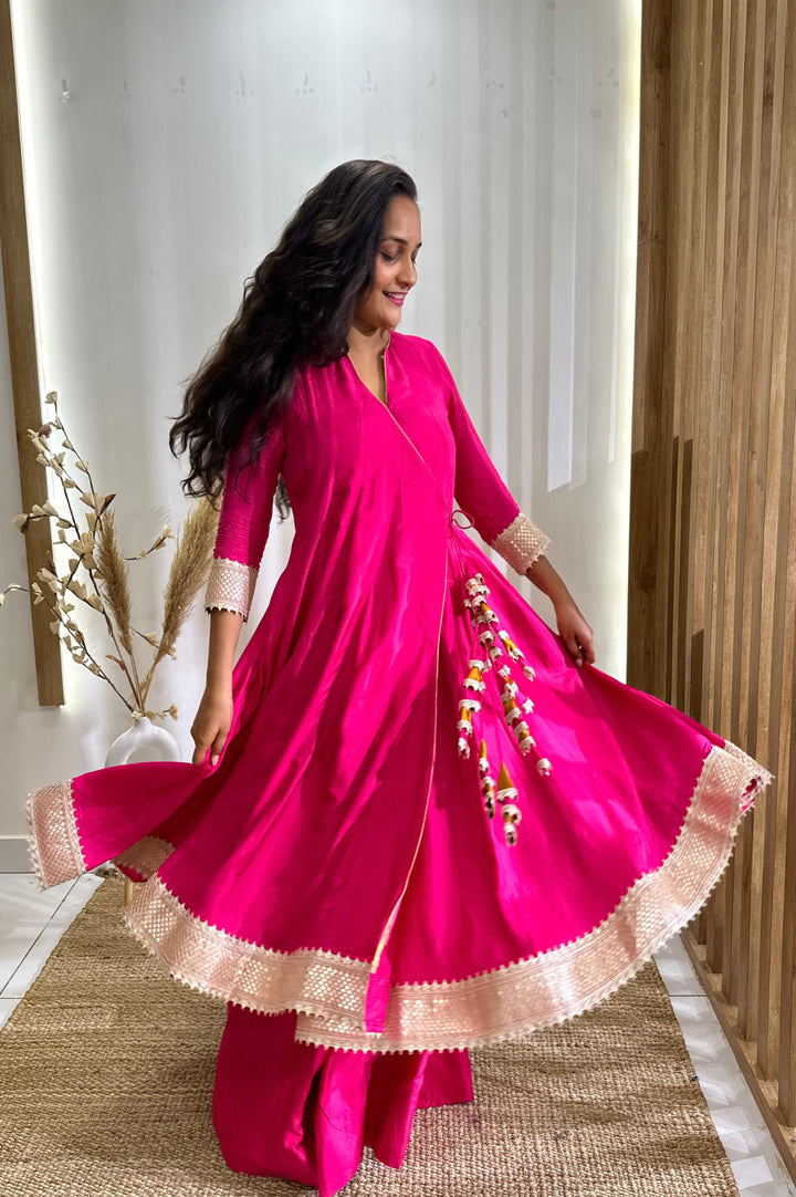 Gorgeous hot pink Anarkali dress featuring Angrakha styling and a contrasting tissue dupatta for special occasions.