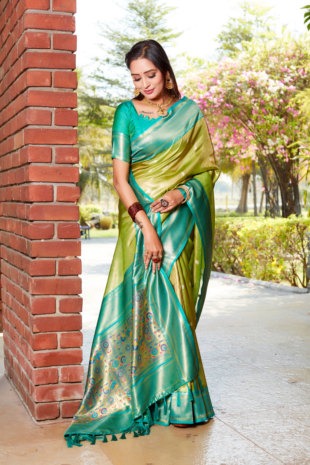 Stunning parrot-green tissue silk saree with intricate pallu and contrast blouse, ideal for traditional events.