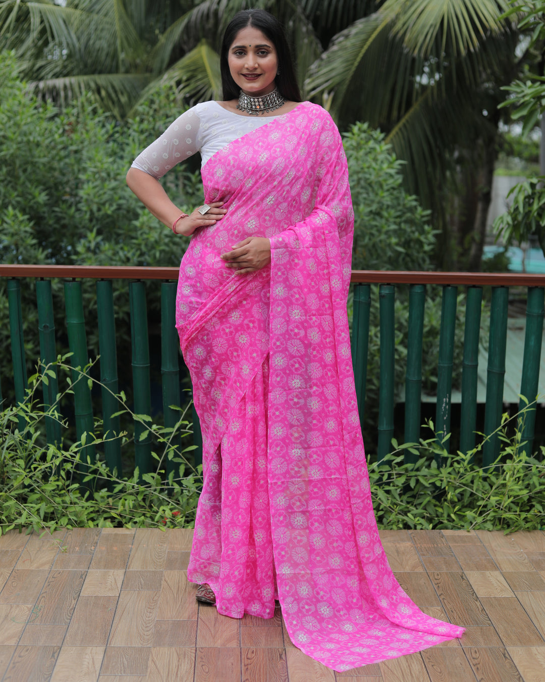 Elegant pink chiffon saree with foil accents, perfect for formal events and celebrations.