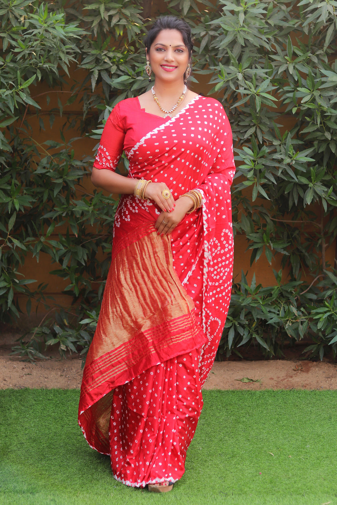 Vibrant red Bandhej silk saree featuring original Bandhej art and Lagdi Patta, designed for festive occasions.