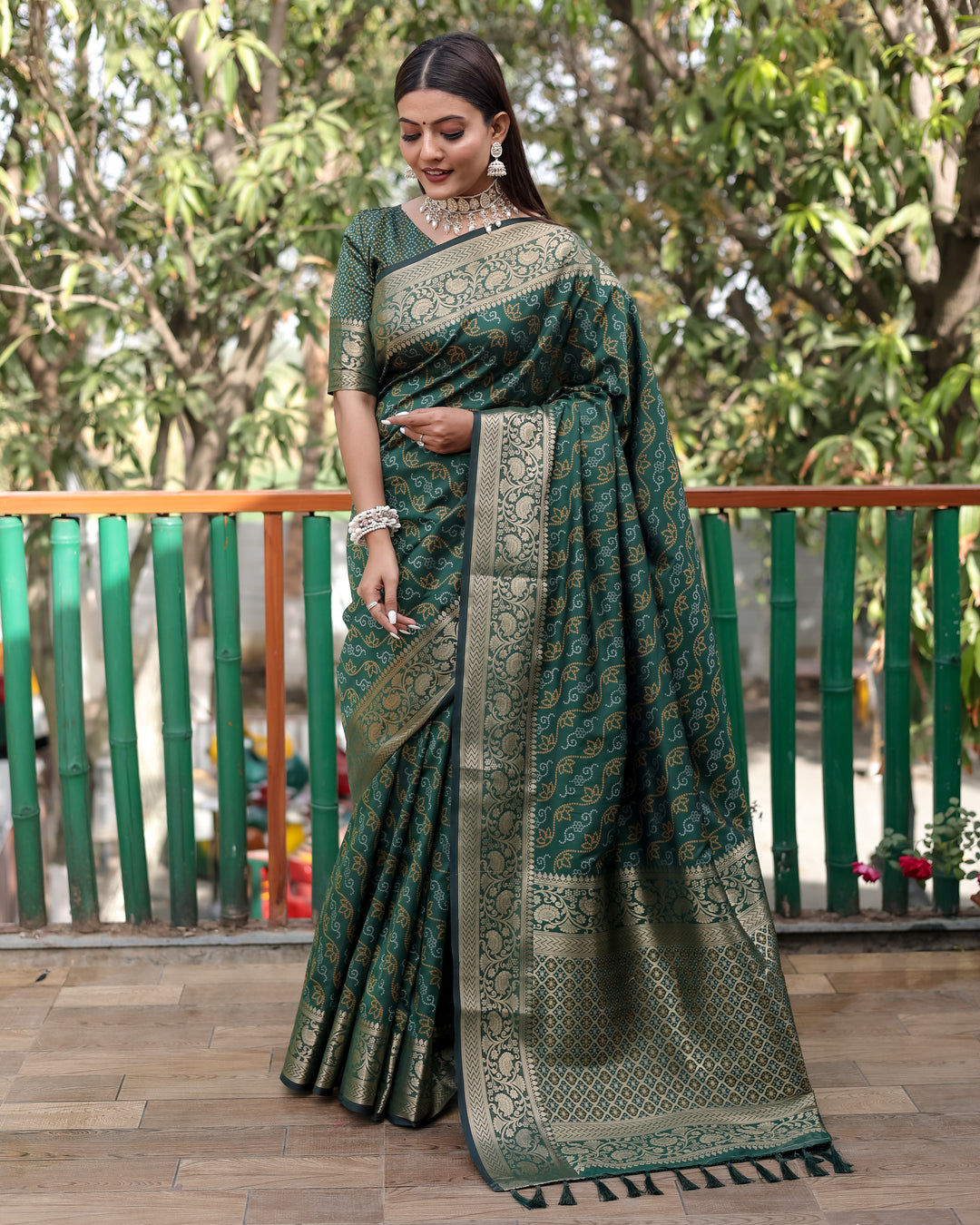 Timeless green Bandhej Patola saree with stunning zari work and regal Kanchi borders, perfect for festive occasions.