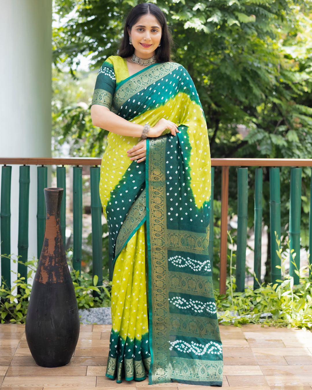 Elegant green Bandhej silk saree with detailed zari work and matching blouse, ideal for festive occasions.