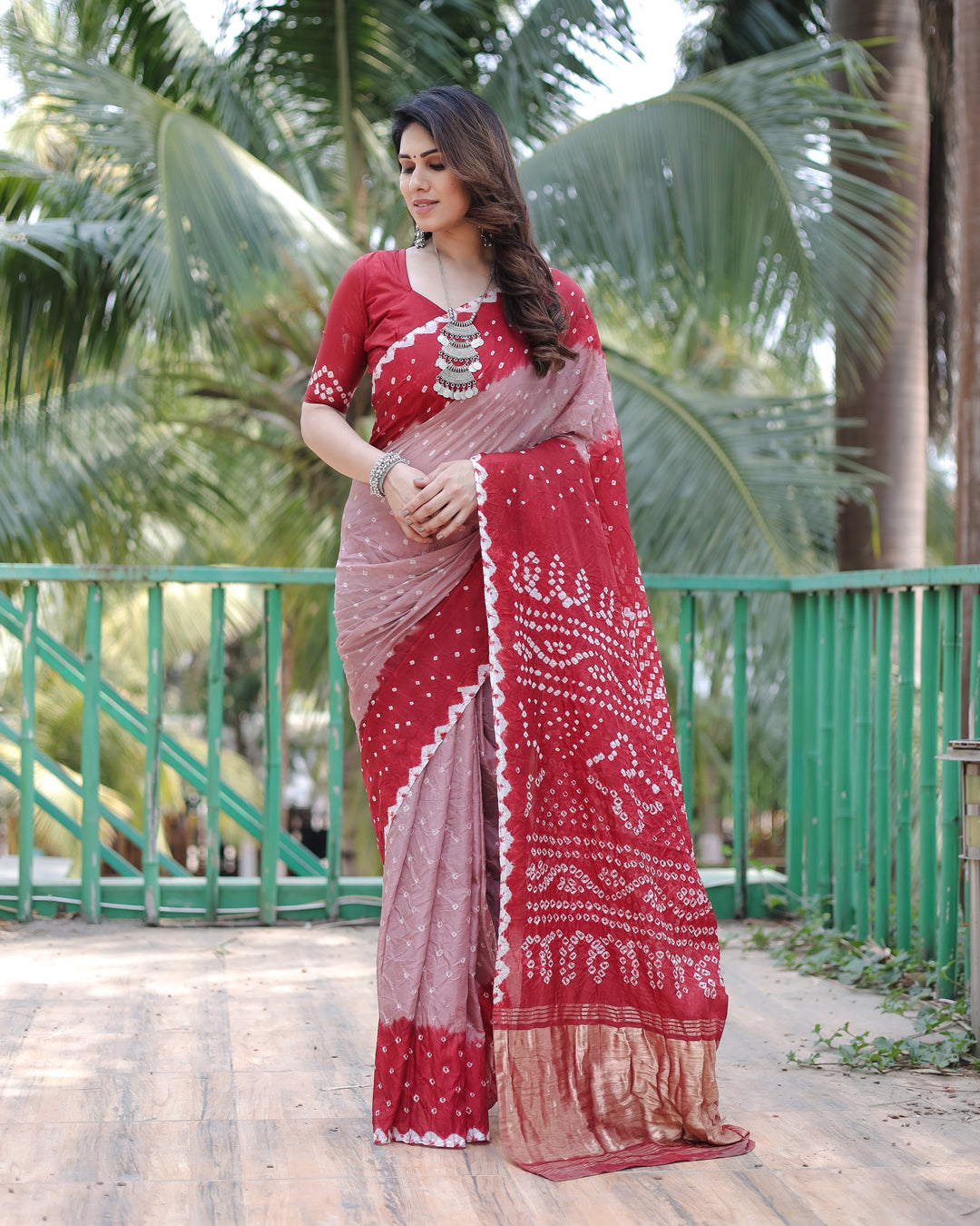 Red Premium Bandhej Silk Drapes with stunning Zari Tissue Pallu and blouse piece for an exquisite look.