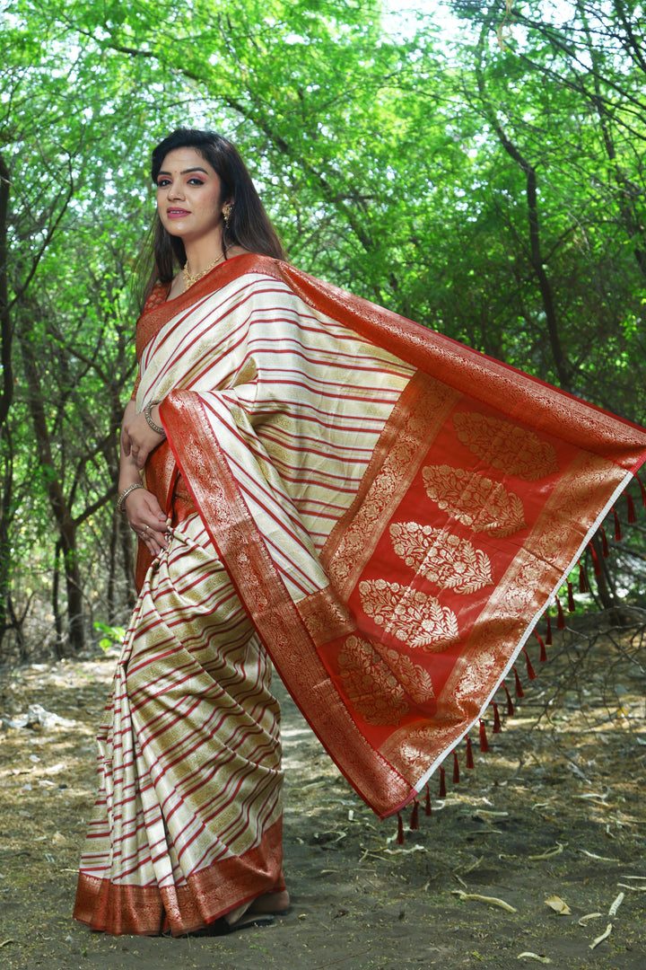 Elegant Cream Leheriya Soft Silk Saree featuring intricate Zari weaving and beautiful border, perfect for festive events.