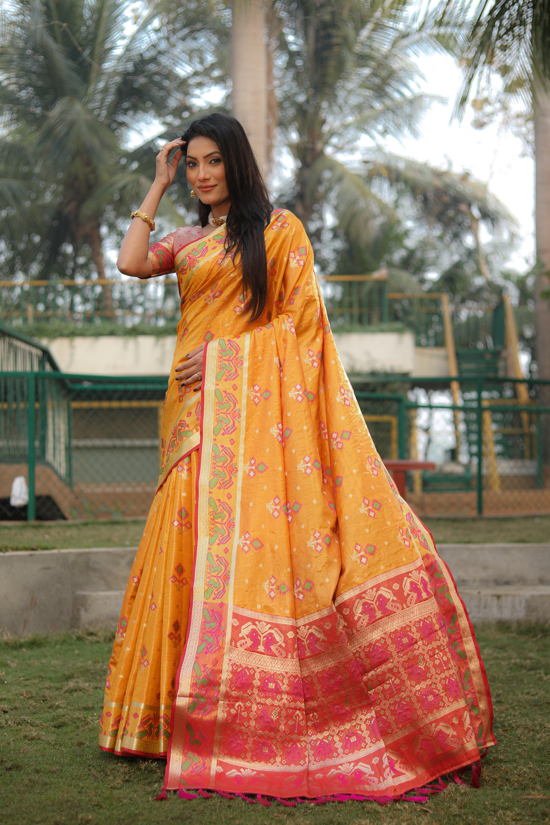 Vibrant yellow organza saree with lightweight Ikkat Patola design, perfect for a traditional look.