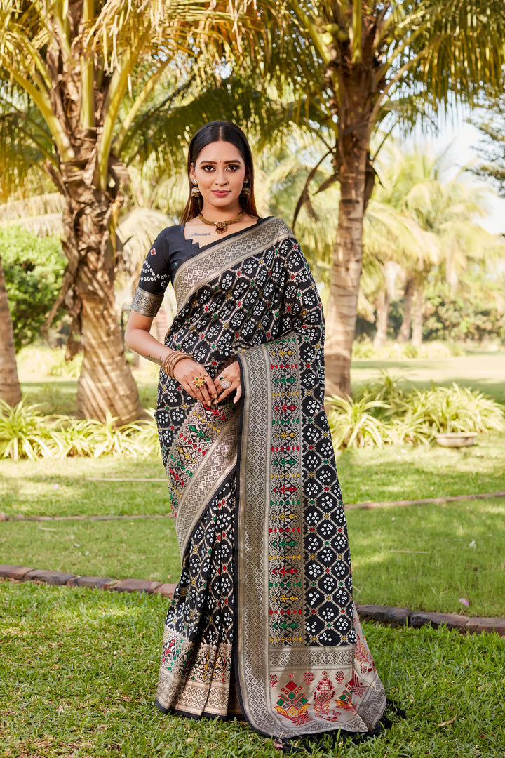 Dark green Gharchola Bandhej silk saree with intricate zari weaving and meenakari borders, ideal for weddings and special occasions.