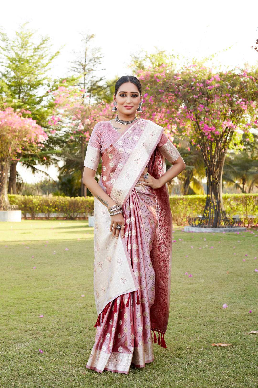 Pink Kanjivaram saree with satin sheen, featuring intricate butta work and a designer satin weaving border for elegance.