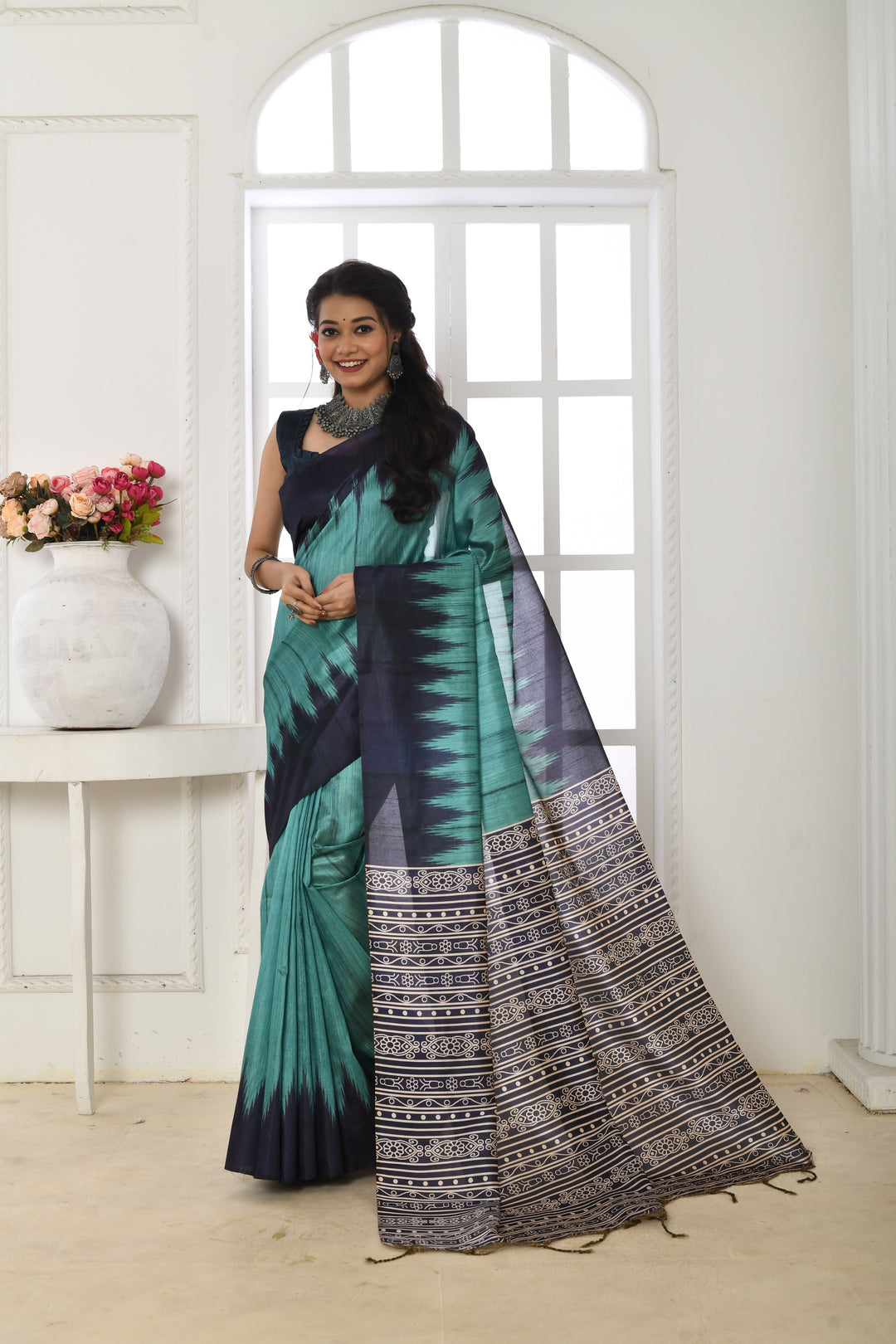 Timeless Tussar silk saree with a printed temple border and a traditional fabric pattern, perfect for festivals.