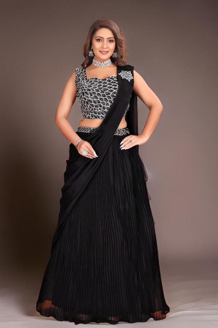 Black draped georgette saree featuring hand-painted floral designs, perfect for elegant evening events and parties.