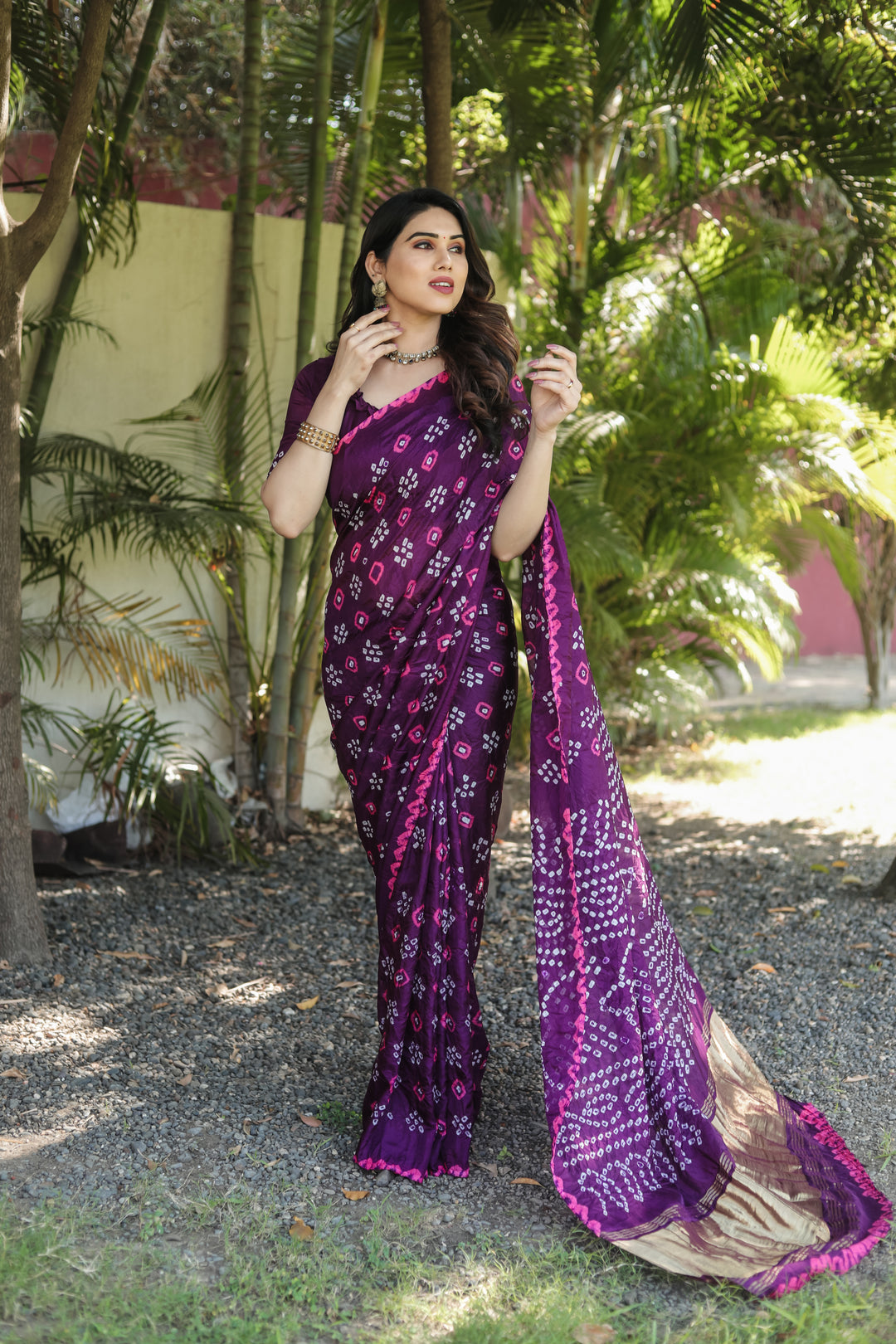 Traditional Bandhej silk saree with luxurious tissue pallu and detailed zari weaving.