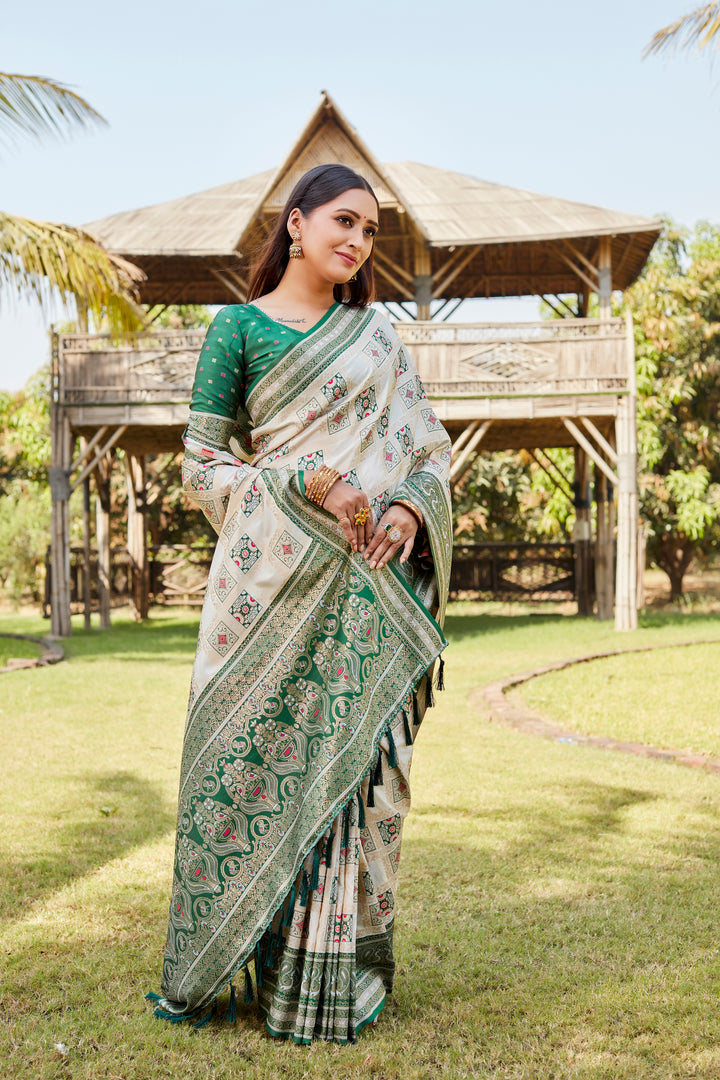 Cream Traditional Kanjivaram soft silk saree with detailed designer borders and delicate patterns.