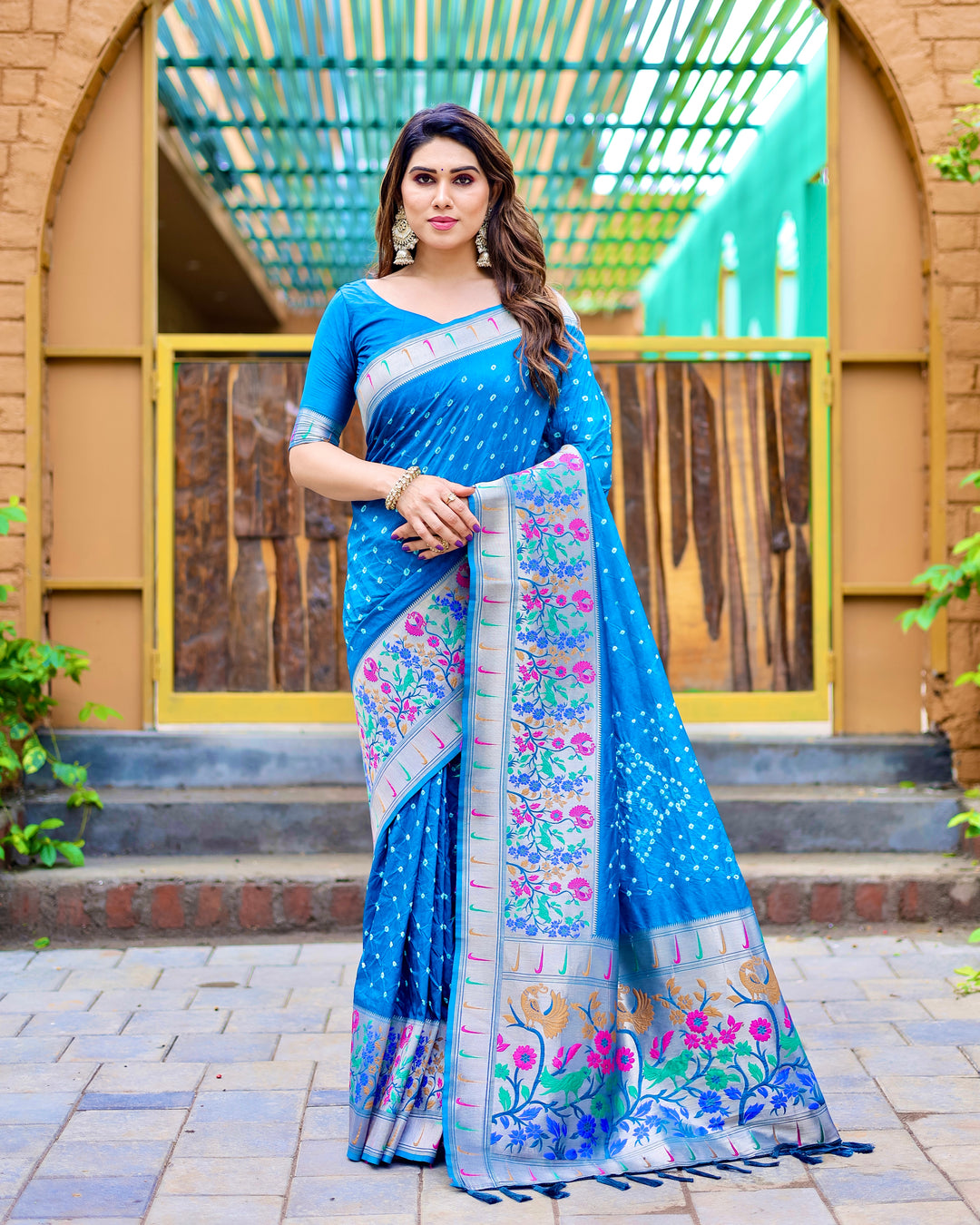 Blue Bandhej Paithani silk saree with Paithani border, zari work, and tassel accents, making it perfect for weddings.