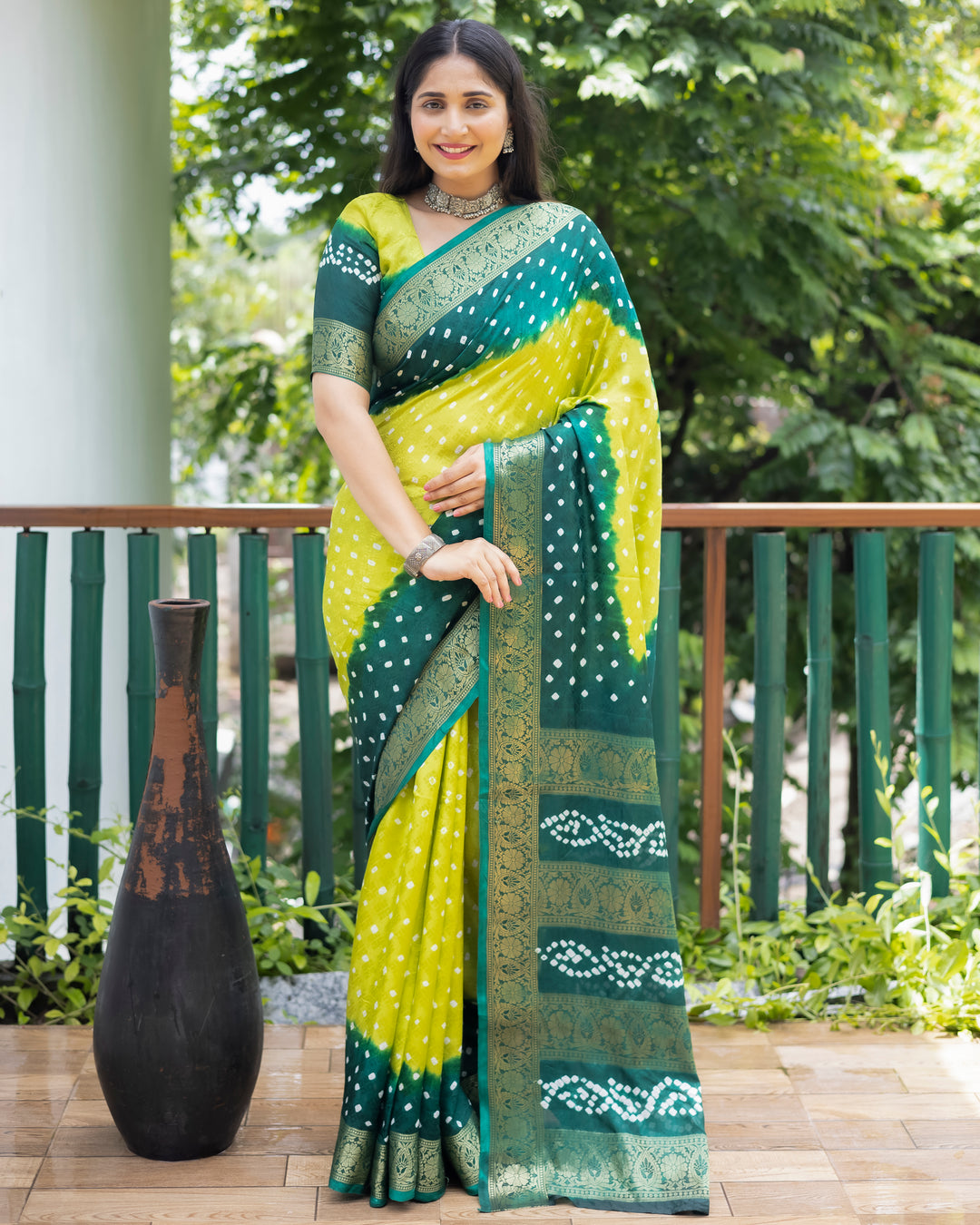 Gorgeous green Bandhej silk saree with intricate zari work and matching blouse, perfect for weddings and bridal wear.