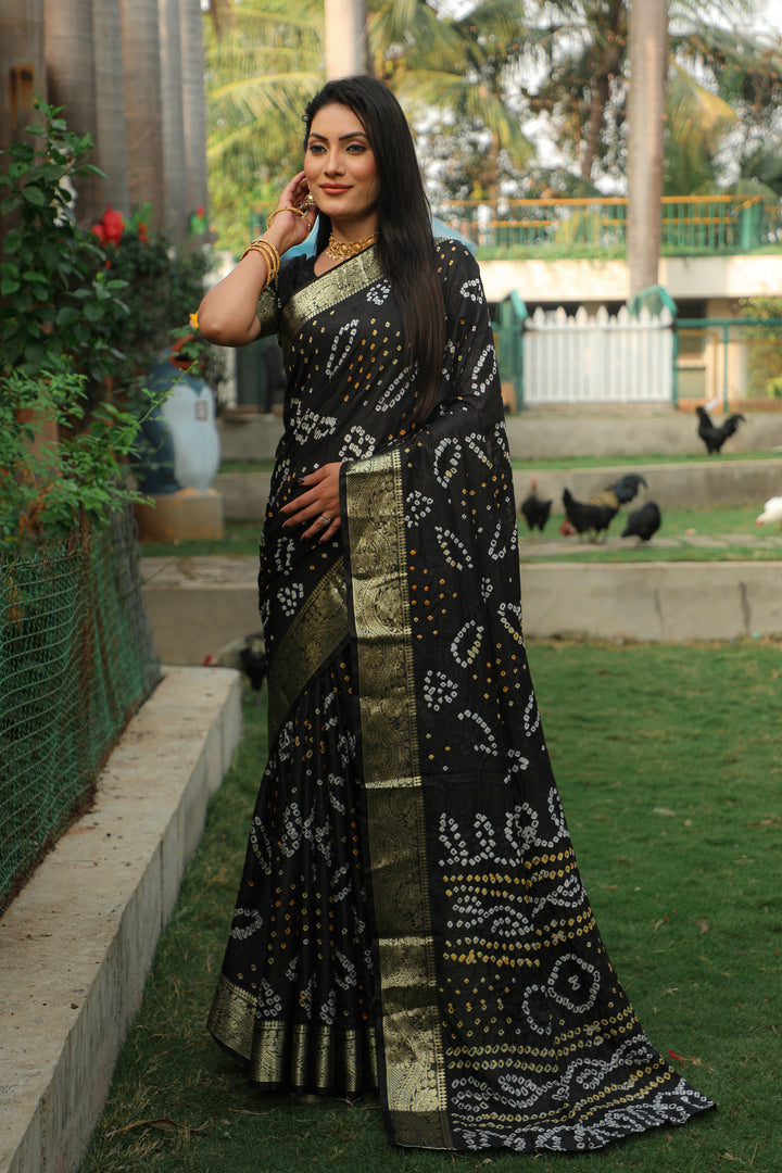 Stunning black Bandhej silk saree adorned with jari weaving and Bandhej pallu, perfect for traditional occasions.