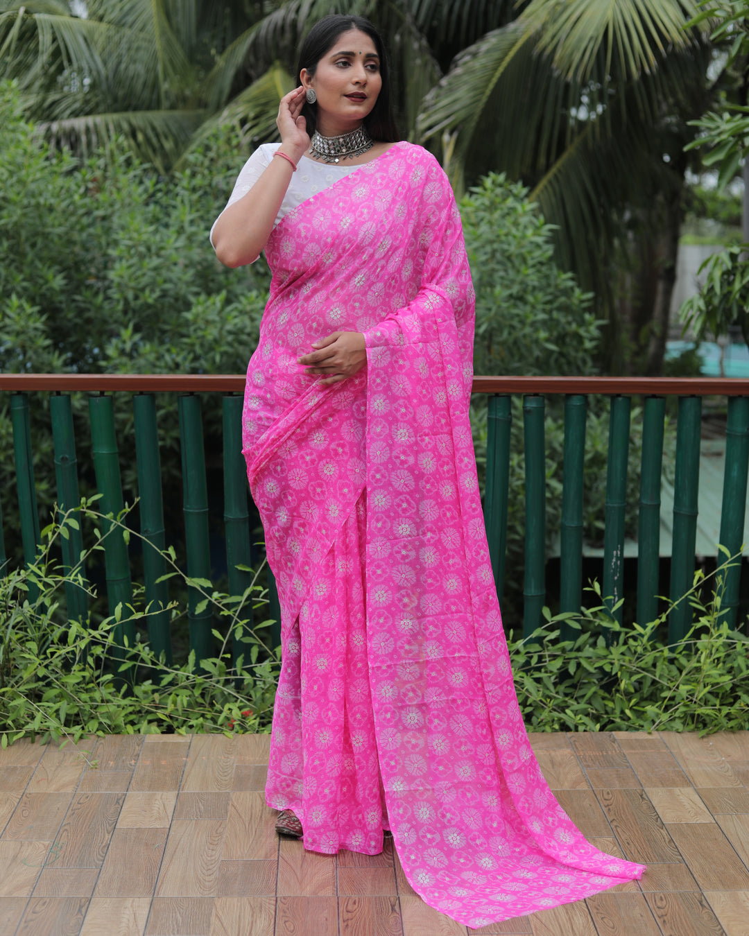 Radiant pink chiffon saree adorned with foil detailing, ideal for weddings and festive parties.