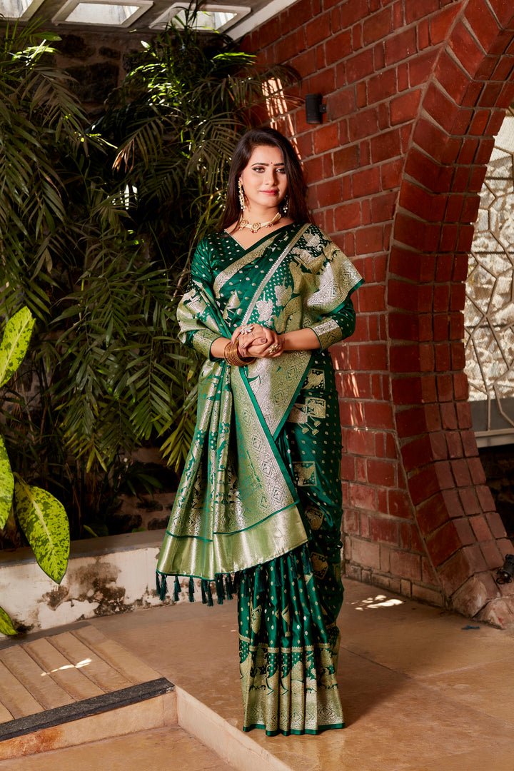 Stunning dark green saree with intricate butta work, designer border, and woven pallu, a must-have for any festive celebration.